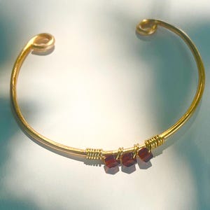 dark red garnet bangle in gold