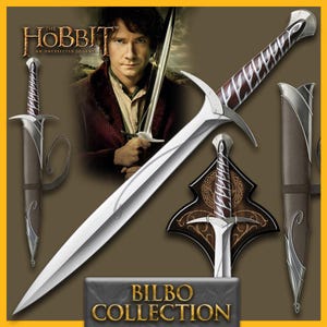 May include: A silver and brown sword from The Hobbit film, with a curved blade and ornate hilt. The sword is displayed with its sheath and a wooden plaque. The text "BILBO COLLECTION" is at the bottom.