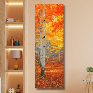 May include: A vertical canvas print of a forest scene in autumn. White birch trees stand tall with vibrant orange and yellow leaves. The forest floor is covered in fallen leaves, creating a warm, inviting landscape.