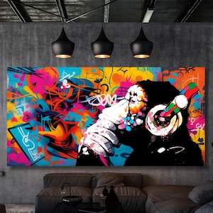 May include: A colorful abstract painting of a monkey wearing headphones and holding a microphone. The background is a vibrant mix of colors and graffiti-style designs.