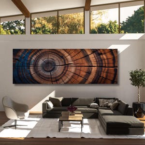 May include: A large, rectangular wall art piece featuring a high-resolution cross-section of a tree trunk. The print displays concentric growth rings in shades of deep brown, tan, and dark blue, showcasing the natural texture of wood grain.