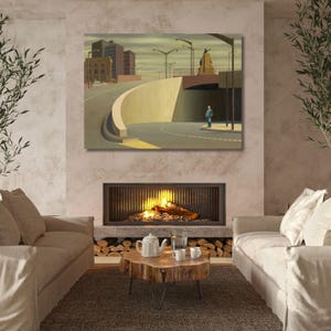 May include: A rectangular wall art print depicting a surreal urban landscape with a curved concrete wall, a lone figure standing on a road, tall buildings, streetlights, and a monument under a muted, cloudy sky in shades of beige, gray, and brown.