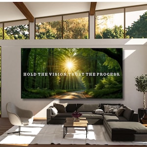 May include: A large rectangular wall art piece featuring a sunlit forest path with green trees and a bright sunburst. The text HOLD THE VISION, TRUST THE PROCESS is printed in white capital letters across the center of the landscape image.
