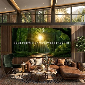 May include: A large rectangular wall art piece featuring a sunlit forest path with the text "HOLD THE VISION, TRUST THE PROCESS." The scene depicts tall trees and a bright sunburst filtering through the canopy, creating a warm, glowing atmosphere.