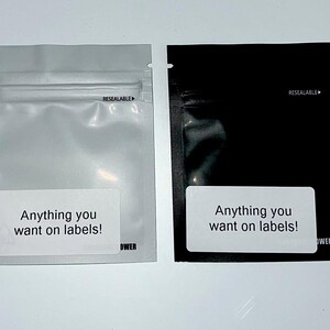 May include: Two resealable plastic bags, one white and one black, with the text "Anything you want on labels!" printed on a white label on each bag.