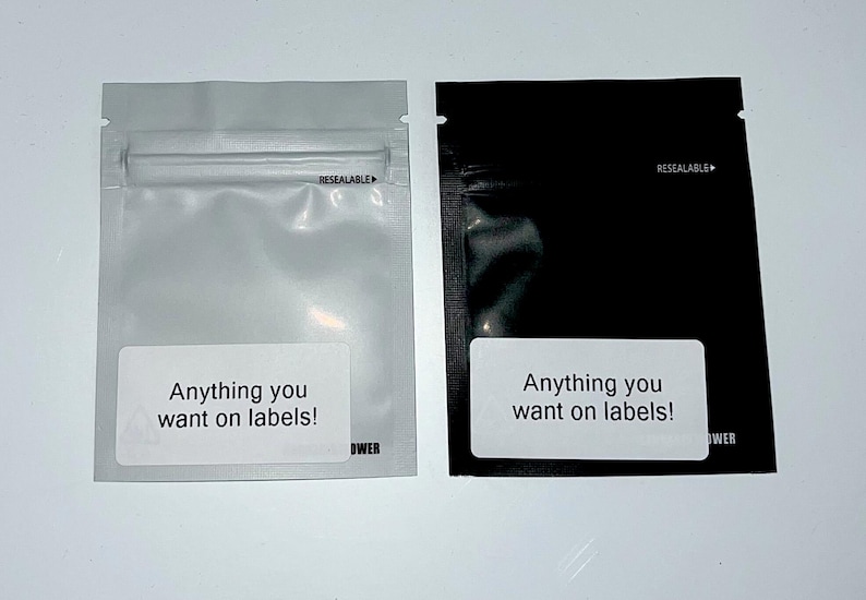 May include: Two resealable plastic bags, one white and one black, with the text "Anything you want on labels!" printed on a white label on each bag.