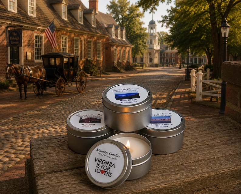 May include: Four round silver metal candle tins with white labels. Three tins are closed, and one is open with a lit candle. Labels feature text including Kittredge Candles, Blue Ridge Mountains, Arlington Cherry, Virginia Beach Summer, and Virginia Is For Lovers.