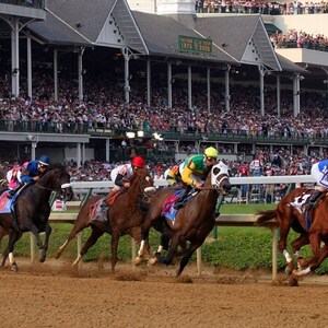 May include: A horse race in progress, with several horses and jockeys competing on a dirt track. The jockeys wear colorful silks, and a large crowd watches from the stands. The scene is set at a racetrack with a grandstand.