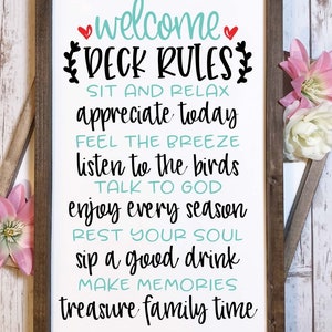 May include: A rectangular wooden sign with a white background and dark brown frame. The text reads: welcome DECK RULES, SIT AND RELAX, appreciate today, FEEL THE BREEZE, listen to the birds, TALK TO GOD, enjoy every season, REST YOUR SOUL, sip a good drink, MAKE MEMORIES, treasure family time.