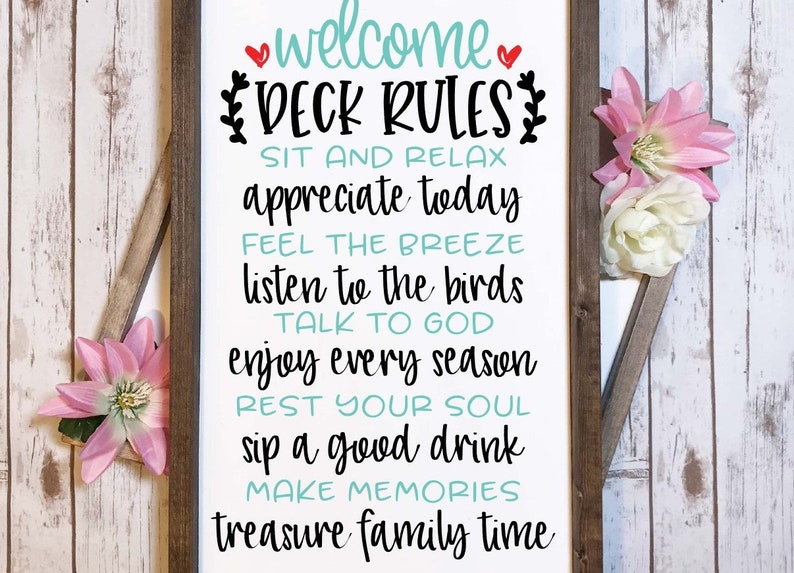 May include: A rectangular wooden sign with a white background and dark brown frame. The text reads: welcome DECK RULES, SIT AND RELAX, appreciate today, FEEL THE BREEZE, listen to the birds, TALK TO GOD, enjoy every season, REST YOUR SOUL, sip a good drink, MAKE MEMORIES, treasure family time.