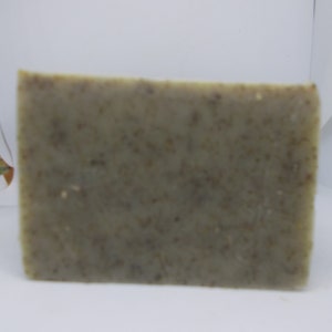 May include: A rectangular bar of green soap with a speckled texture.
