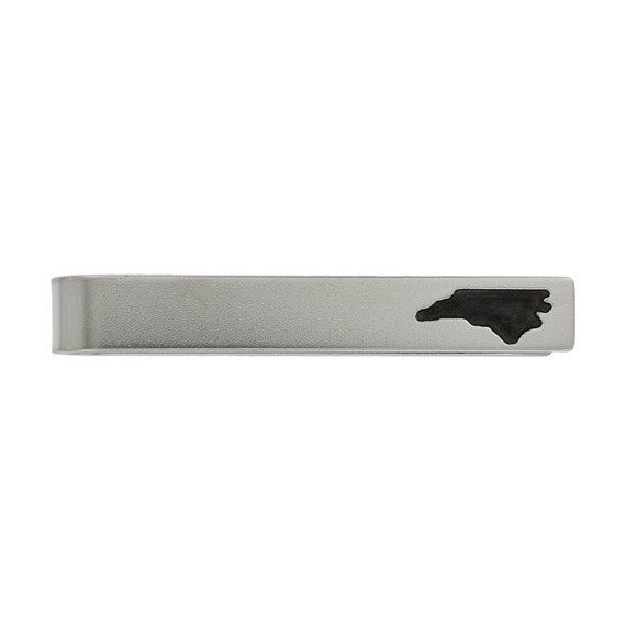 A silver tie clip engraved with YOUR actual company logo or custom design — sharp, wearable branding that a maker hand-finishes to order.