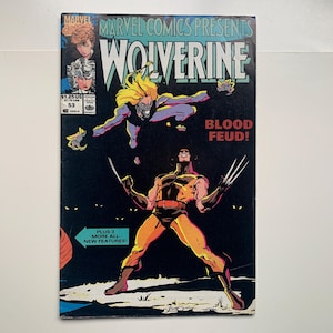 May include: A vintage comic book cover featuring Wolverine in a dynamic pose with claws extended. The title "Wolverine" is prominently displayed, with the text "BLOOD FEUD!" and "PLUS 3 MORE ALL NEW FEATURES!" also visible. The cover has a dark background with illustrations.