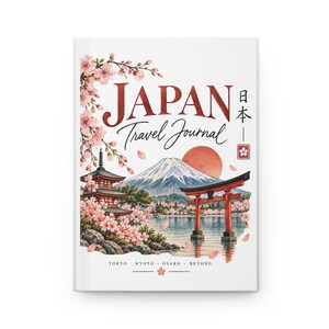 May include: A white travel journal with the text JAPAN Travel Journal, Tokyo, Kyoto, Osaka, Beyond. The cover features a watercolor illustration of Mount Fuji, a red torii gate, a pagoda, and pink cherry blossoms against a white background.