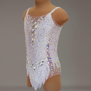 May include: White leotard with a crystal design. The leotard has a scoop neck and a racerback style. The crystals are arranged in a geometric pattern.