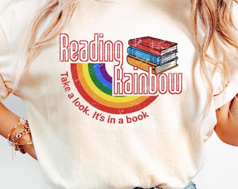 May include: A white t-shirt with a rainbow and the text "Reading Rainbow. Take a look. It's in a book."