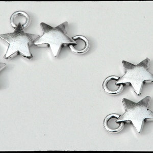 Star charm, puffy, stamping blank, silver tone metal alloy.  Tiny 9mm. Quantity 10.  For necklaces, earrings, charm bracelets. (2-15)