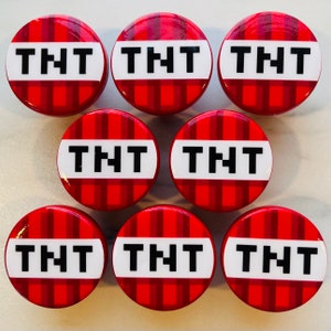 May include: Seven red and white checkered round buttons with the word "TNT" printed in white letters.