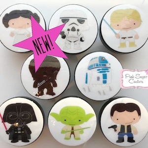May include: Set of 7 Star Wars character themed knobs. Each knob features a different character from the Star Wars franchise, including Darth Vader, Yoda, Princess Leia, Chewbacca, R2-D2, Luke Skywalker, and Stormtrooper. The knobs are white with black outlines and are approximately 2 inches in diameter.