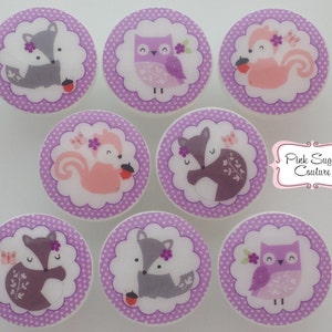 May include: Eight round buttons in purple and white with a white background and a purple polka dot border. Each button features a different woodland animal: a fox, an owl, and a squirrel. The animals are depicted in a cartoon style with pink, grey, and purple colours.