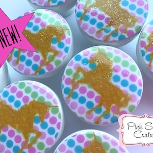 May include: Set of six white round knobs with a gold glitter unicorn silhouette on a pink, blue, and green polka dot background.  The knobs are labeled "NEW!"
