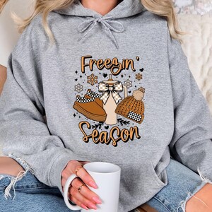 Freezin’ Season, Winter Season Hoodie, It’s Literally Freezing Hoodie, Unisex Family Winter Vibes Hoodie, Winter Coquette Bow Hoodie Gift