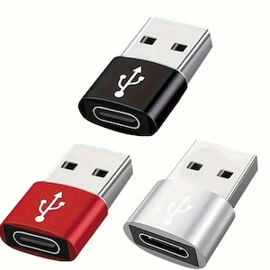 May include: Three USB-C to USB-A adapters in black, red, and silver. The adapters are small and rectangular with a USB-A connector on one end and a USB-C connector on the other.