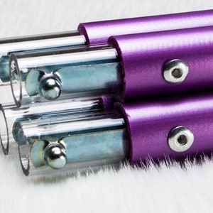 May include: Three purple metal poles with clear plastic ends and silver metal connectors. Each pole has a silver metal screw on the side.