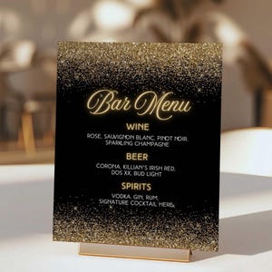 May include: A black bar menu sign with gold glitter at the top and bottom. The words "Bar Menu" are in gold script. The menu lists wine, beer, and spirits with specific drink options.