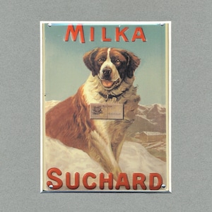 May include: Vintage Milka chocolate advertisement featuring a brown and white Saint Bernard dog sitting in the snow with a box of Milka chocolate in its paws. The text "Milka Suchard" is printed in red letters on the sign.