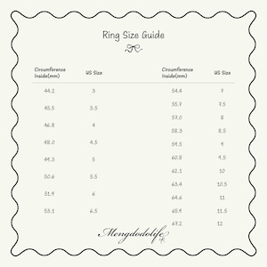 May include: A black and white ring size guide chart with a scalloped border. The table lists circumference in millimeters alongside corresponding US ring sizes ranging from 3 to 12. The text Mengdodolife is printed at the bottom of the chart.