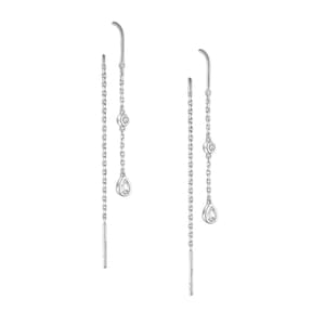 May include: A pair of silver dangle earrings with two clear pear-shaped gemstones and a smaller round gemstone on each earring.