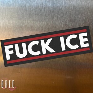 FUCK ICE car magnet flat lay on a neutral surface, minimalist anti ICE political magnet with bold typography.