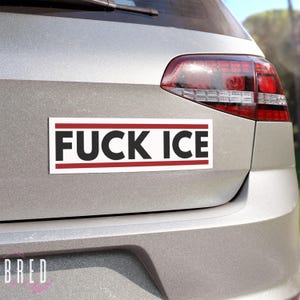 FUCK ICE white car magnet shown on the back of a vehicle in daylight, horizontal anti ICE protest magnet with high contrast lettering.