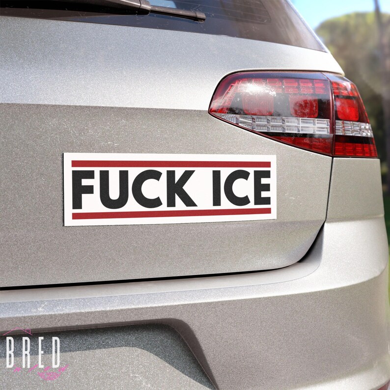 FUCK ICE white car magnet shown on the back of a vehicle in daylight, horizontal anti ICE protest magnet with high contrast lettering.