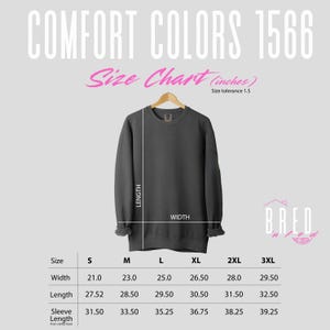 Size chart for Comfort Colors 1566 crewneck sweatshirt featuring measurements in inches styled with a pink Bred N Fed logo and modern typography.