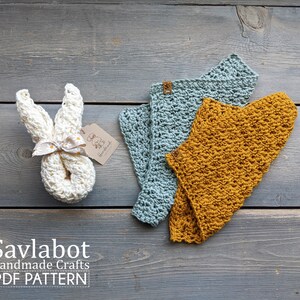 May include: A crochet bunny toy with a white ribbon and a tag that says "Savlabot Handmade Crafts". Two crochet baby bibs, one in a light blue color and the other in a mustard yellow color, are also shown. The text "PDF PATTERN" is visible at the bottom of the image.