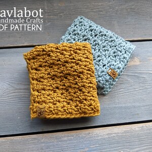 May include: Two crocheted squares, one mustard yellow and one light blue, with a brown leather tag with the text "Savlabot Handmade Crafts PDF Pattern" on each.