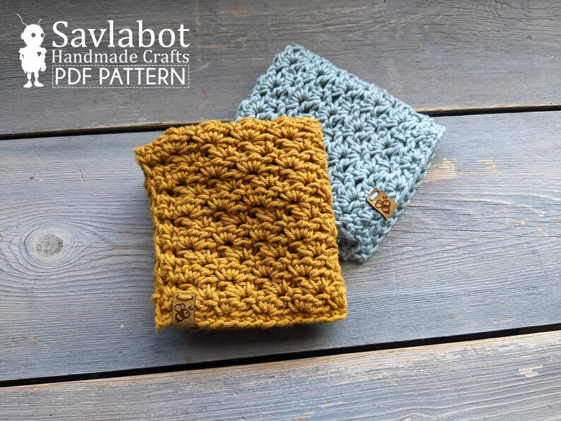 May include: Two crocheted squares, one mustard yellow and one light blue, with a brown leather tag with the text "Savlabot Handmade Crafts PDF Pattern" on each.