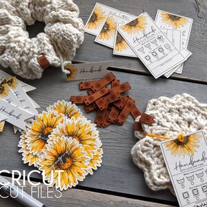 May include: A collection of handmade items featuring a sunflower theme. The items include a crocheted headband, a crocheted coaster, a set of sunflower stickers, and several tags with the word "Handmade" and care instructions.
