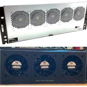 May include: A close-up of a silver server rack with four black fans. The fans have a honeycomb design and are visible through a metal grate. The rack has a black metal frame and a label that reads "ASRock".
