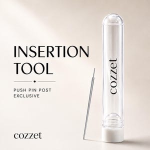 May include: A thin metal insertion tool for push pin posts, accompanied by a clear cylindrical storage tube with a white base. The tube features the brand name cozzet printed vertically, and the text INSERTION TOOL PUSH PIN POST EXCLUSIVE.