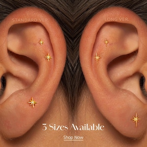 May include: Close-up of two ears, each adorned with gold star-shaped earrings. The earrings are in different sizes and placements. Text at the bottom reads "3 Sizes Available" and "Shop Now".