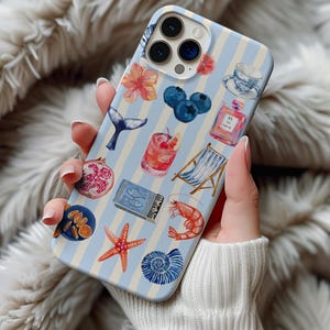 May include: A light blue and white striped phone case featuring watercolor illustrations of a cocktail, blueberries, a starfish, a seashell, and other beach-themed images. The case has a glossy finish and is held by a person.