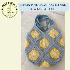 May include: A crocheted tote bag with a light blue background and yellow lemon slice designs. The bag has blue straps and the text "LEMON TOTE BAG CROCHET AND SEWING TUTORIAL". The bag is handmade and features a unique, colorful design.