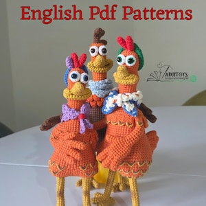 May include: Three handmade crochet chicken dolls in orange, yellow, and brown. Each chicken has a unique hat and scarf. The text "English Pdf Patterns" is displayed in red at the top of the image. The dolls are standing on a white surface.