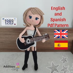 May include: Crochet doll pattern in English and Spanish. The doll is holding a guitar and has blonde hair and blue eyes. The pattern includes instructions for making the doll, guitar, and clothing. The pattern is available as a PDF download.