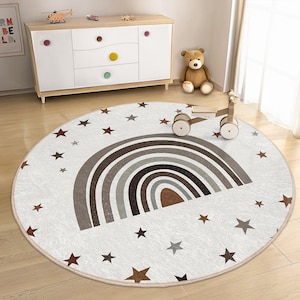 May include: A round, white play mat with a brown rainbow design and scattered white stars. The mat is perfect for a child's playroom or bedroom.