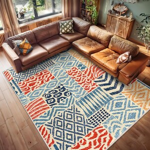 May include: A colorful area rug with a patchwork design featuring geometric patterns in shades of blue, red, orange, and white. The rug is laid out on a wooden floor in a living room setting.