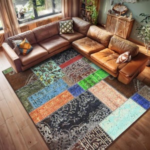 Puede incluir: Una alfombra de patchwork multicolor con una variedad de patrones. La alfombra presenta parches rectangulares en tonos de azul, naranja, verde y marrón. La alfombra está colocada sobre un suelo de madera, con un sofá seccional de cuero marrón en el fondo.